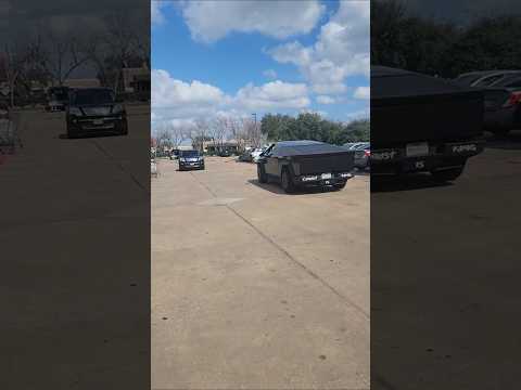 Tesla truck young drive with wrapped, tagged and playing gospel music cruising the HEB parking lot