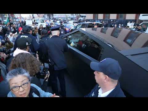 Protesters FLIP OFF Cyber Truck as they march against ICE arrest of  Mahmoud Khalil