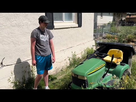 Rescuing an old John Deere LT166 riding mower from the weeds